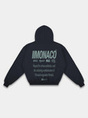 Navy Monaco graphic hoodie back mockup with green Monaco branding, statement text, hood and ribbed waistband.