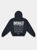 Navy tapered hoodie back mockup by Monaco with light gray branding, statement typography and ribbed waistband.