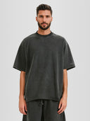 Model wearing the Foundation Raw Hem Tee in Faded Black with tonal Monaco sleeve logo — Monaco Social Club streetwear