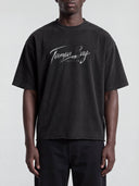 Front view of a model wearing the faded black Monaco Social Club Tampa Bay Blur Tee with white chest lettering and dropped shoulders.